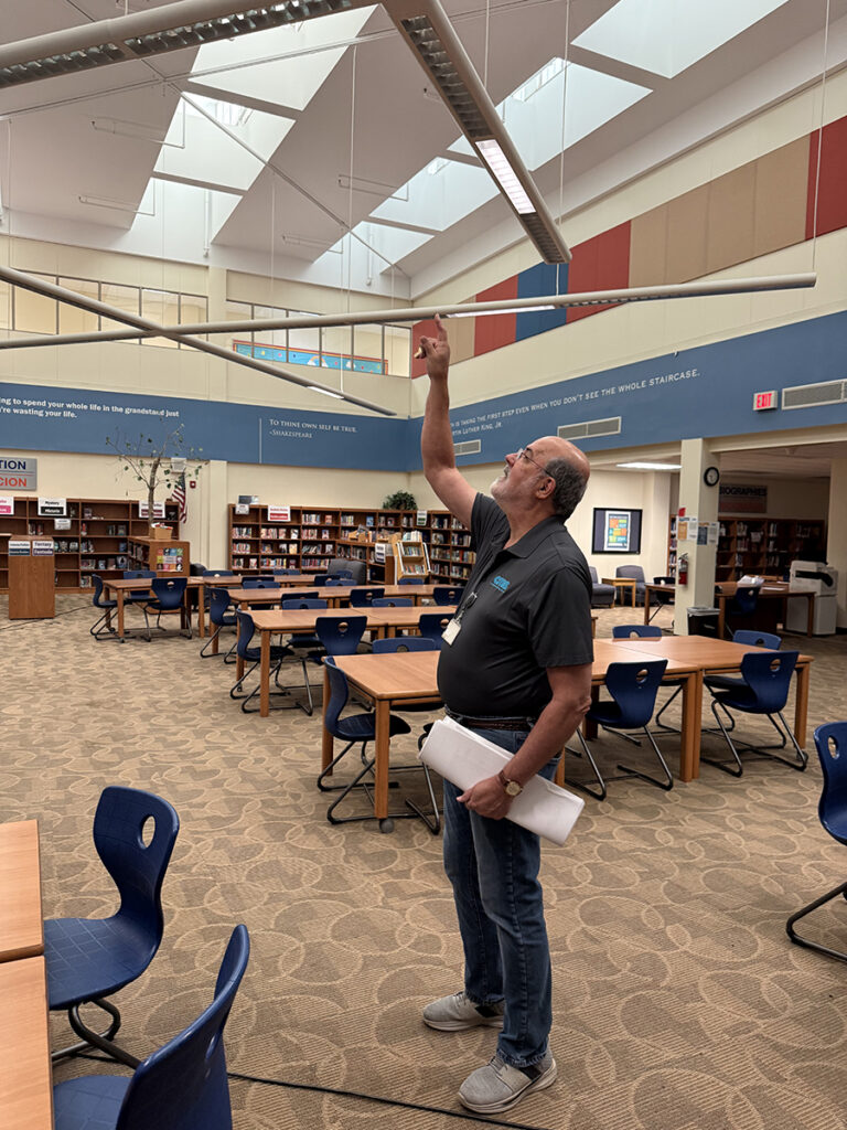 Charlotte Mecklenburg Schools Project Manager inspecting an LED Installation